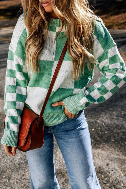 a woman wearing a green and white checkered sweater